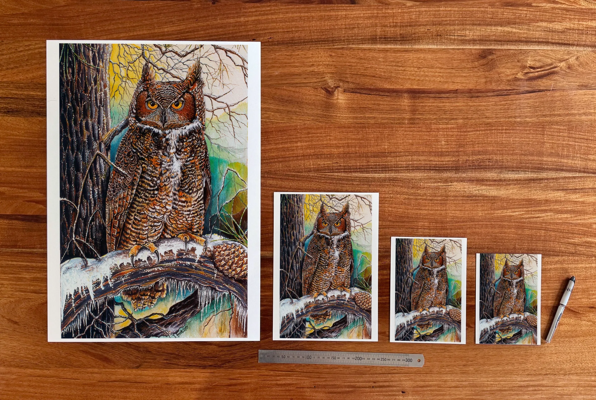 Horned Owl in the Snow at each available size: A2 (420 × 594 mm), A4, A5 and 5 × 7 in (127 × 178 mm), beside a 30 cm ruler. The 5 × 7 in print shows the whole painting, with white strips of about 7 mm at each side.