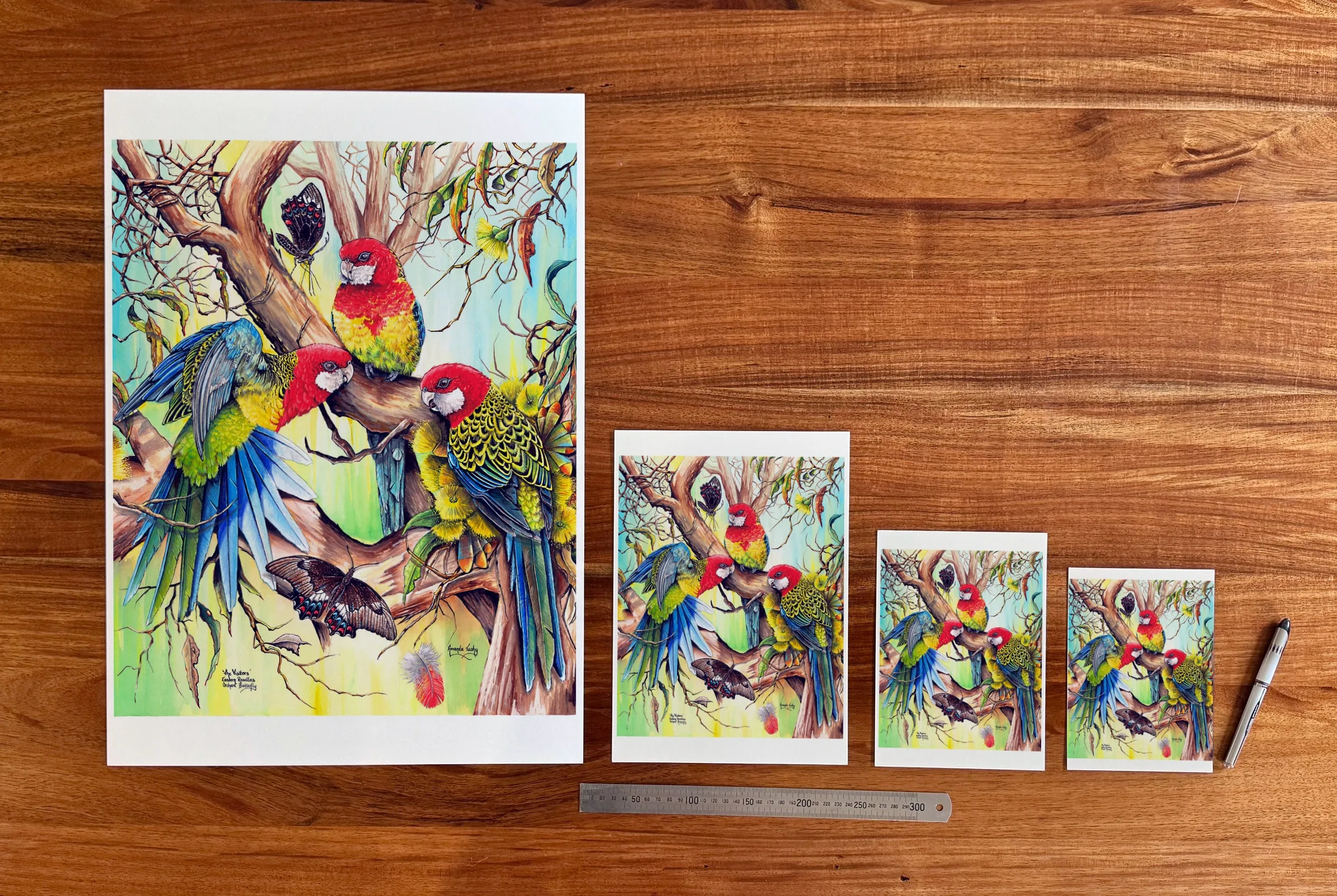 The Visitors at each available size: A2 (420 × 594 mm), A4, A5 and 5 × 7 in (127 × 178 mm), beside a 30 cm ruler. The 5 × 7 in print shows the whole painting, with white strips of about 10 mm top and bottom.