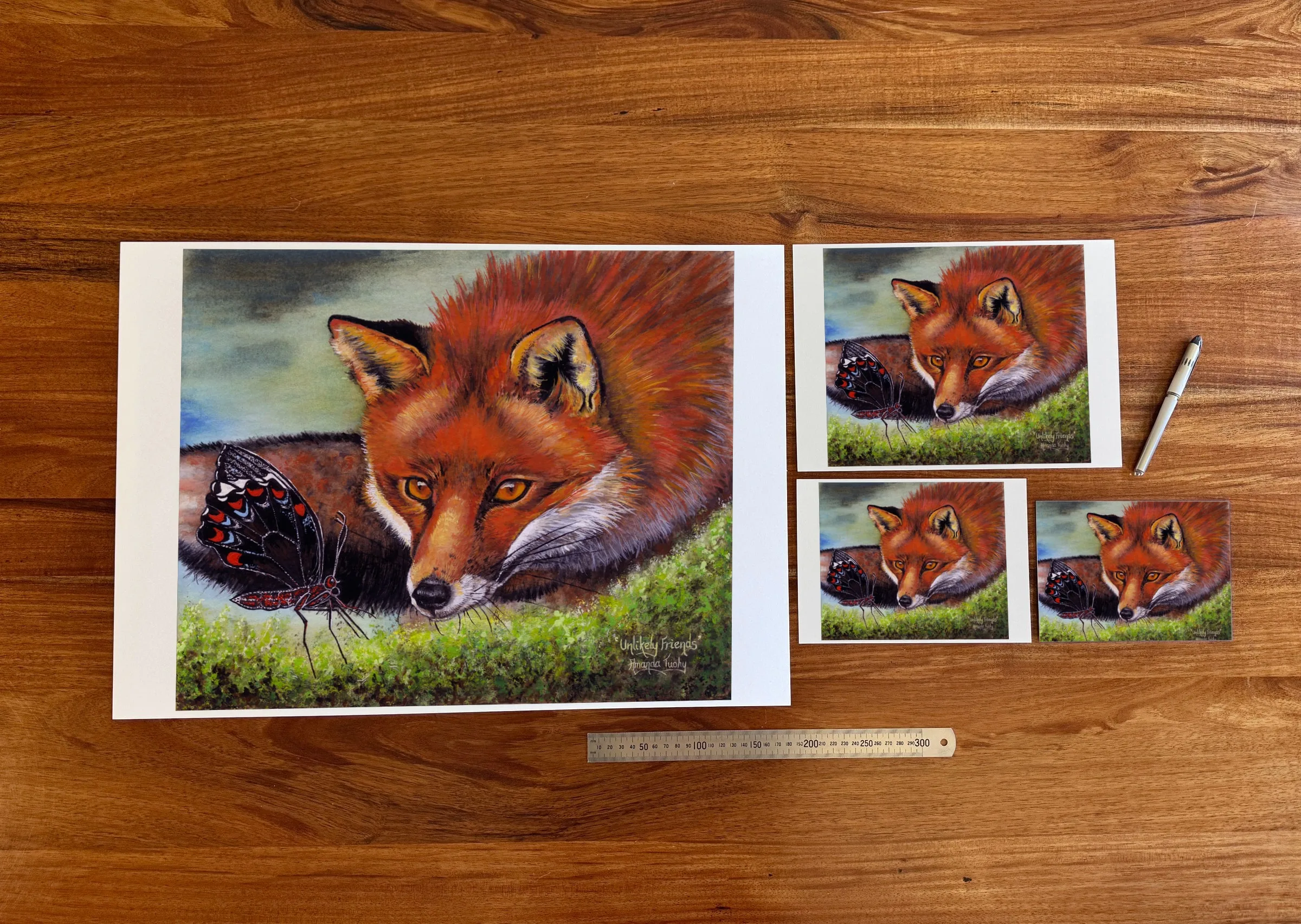 Unlikely Friends at each available size: A2 (420 × 594 mm), A4, A5 and 5 × 7 in (127 × 178 mm), beside a 30 cm ruler.